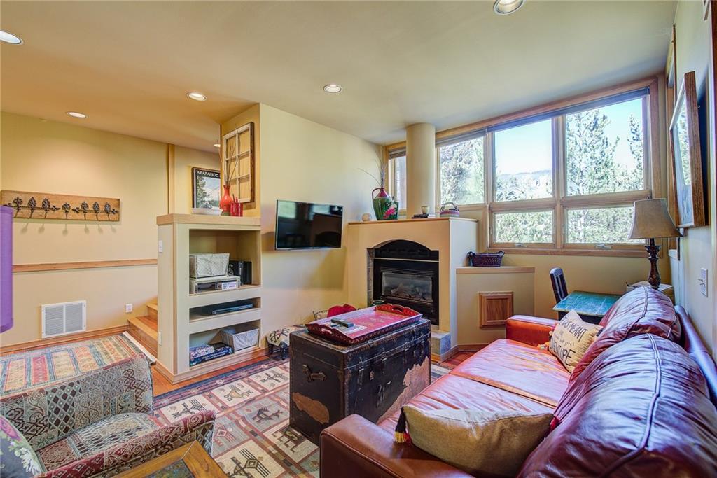 2027 Soda Ridge Road, Unit 1934 Keystone, CO 80435 - Photo 8 of 21 a living room with furniture and a fireplace