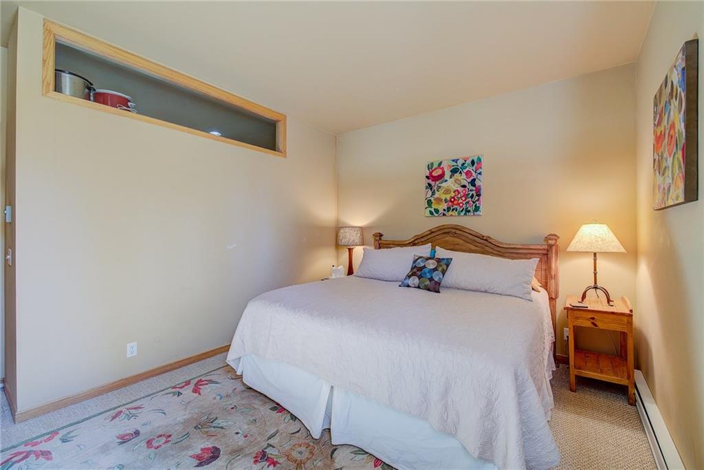 2027 Soda Ridge Road, Unit 1934 Keystone, CO 80435 - Photo 10 of 21 a bedroom with a bed and a lamp on the dresser