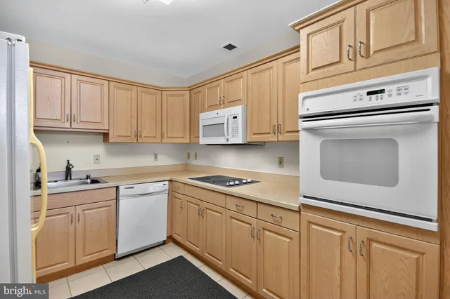 a kitchen with cabinets stainless steel appliances and a sink