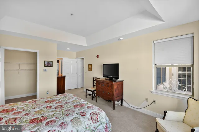 a bedroom with a bed and a television