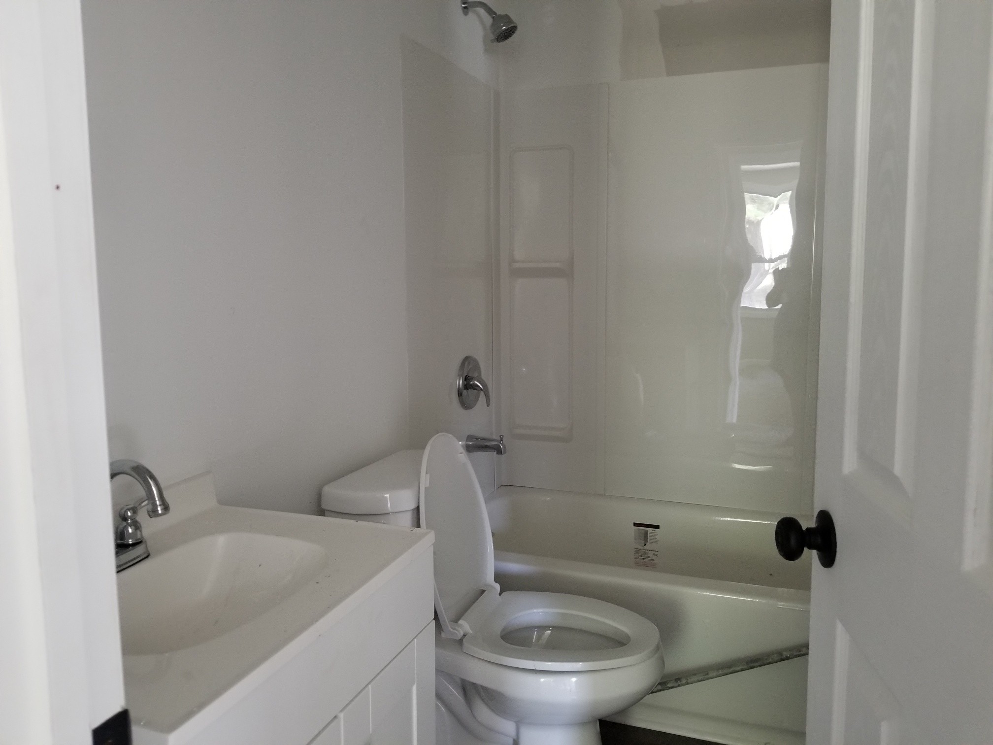 4440 Old Metal Road Palmyra, TN 37142 - Photo 16 of 21 a white toilet sitting next to a bathroom sink and tub