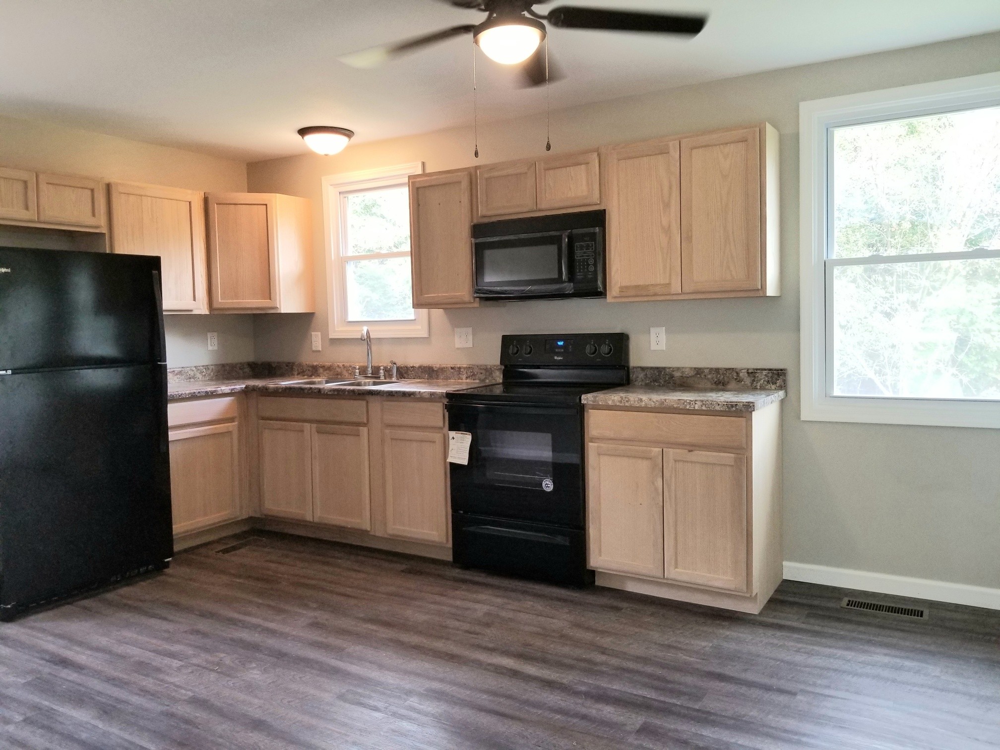 4440 Old Metal Road Palmyra, TN 37142 - Photo 7 of 21 a kitchen with a white cabinets and wooden floor
