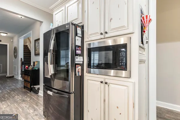 a bedroom with a bed and a flat tv screen on dresser