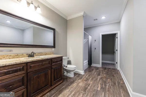 a living room with furniture a chandelier and a flat screen tv