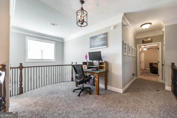 a bedroom with a bed and chandelier