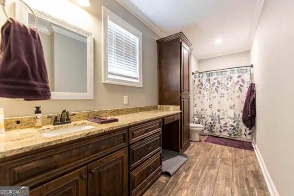 a view of a house with a yard and basketball court