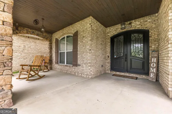 a view of a hallway with entryway windows wooden floor and front door