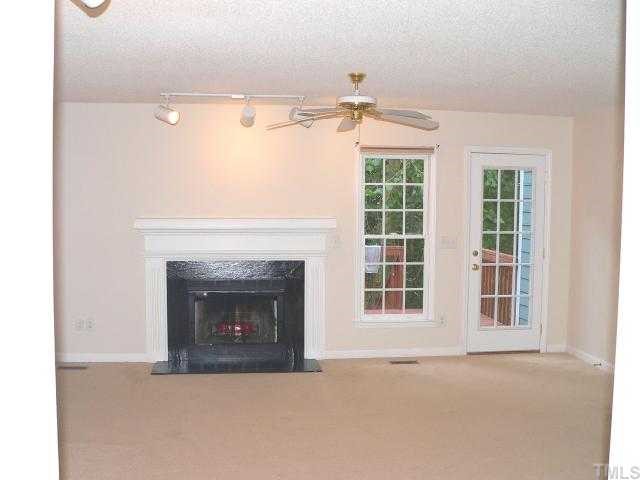 6742 Queen Annes Drive Raleigh, NC 27613 - Photo 3 of 12 a view of an empty room with a fireplace and a window