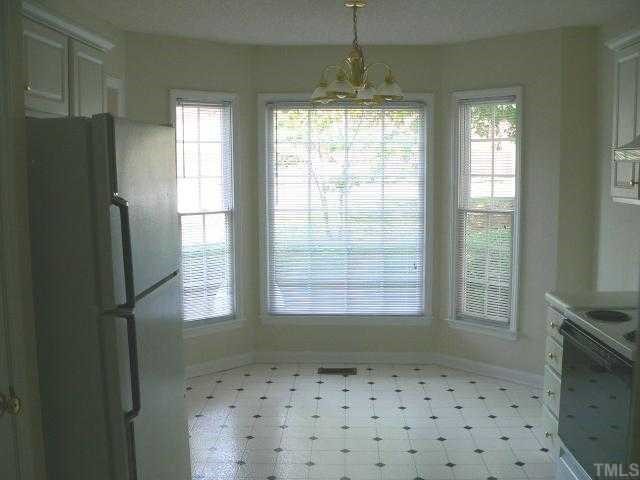 6742 Queen Annes Drive Raleigh, NC 27613 - Photo 4 of 12 a bathroom with a refrigerator a sink and a window