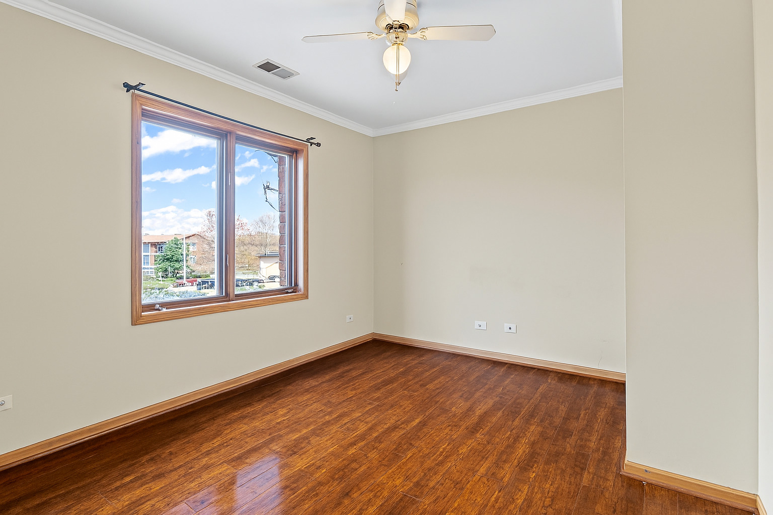 10710 Central Avenue, Unit 3D Chicago Ridge, IL 60415 - Photo 19 of 24 a view of an empty room with wooden floor and a window