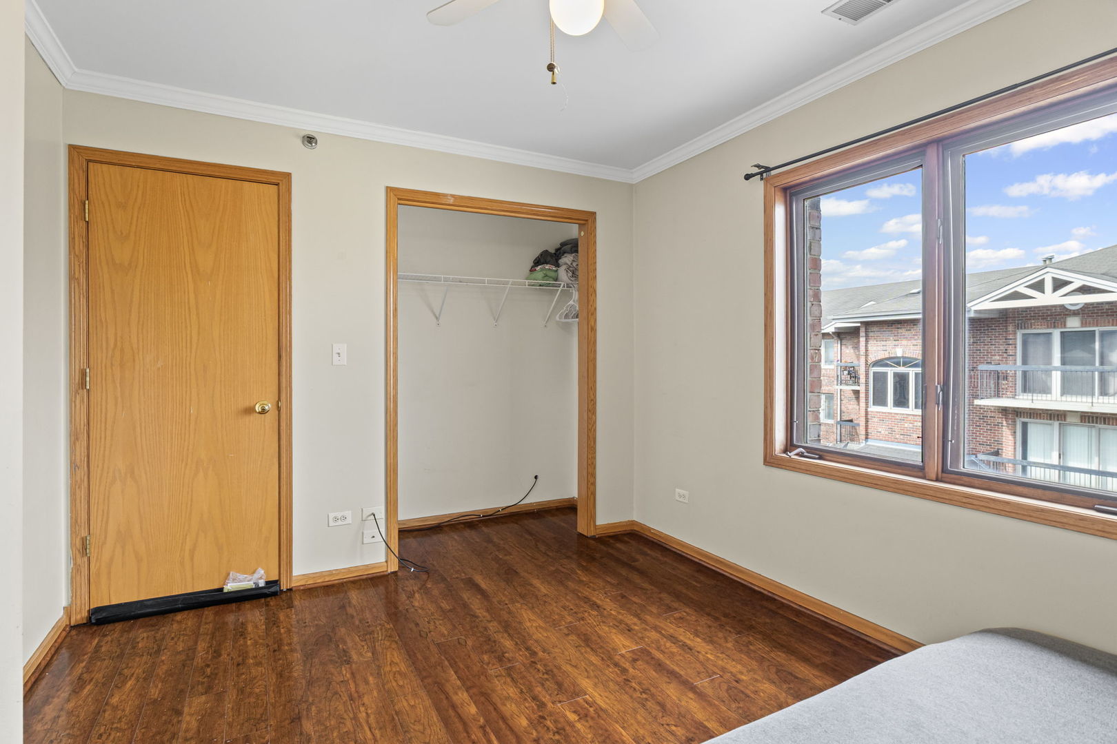 10710 Central Avenue, Unit 3D Chicago Ridge, IL 60415 - Photo 20 of 24 an empty room with wooden floor and a window