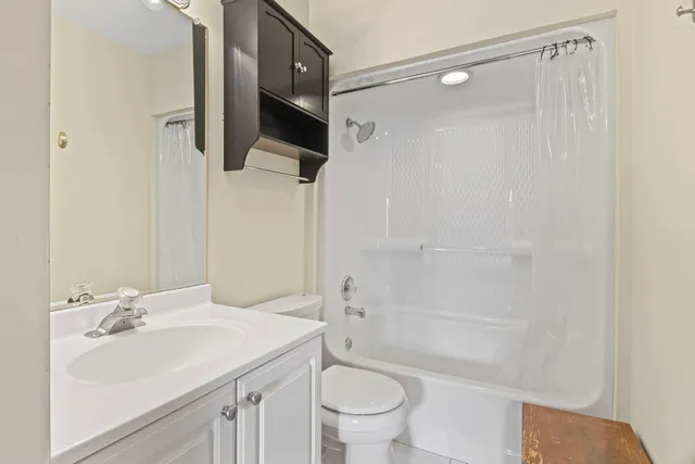 a bathroom with a sink toilet a mirror and shower