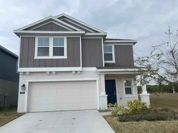 a front view of a house with garage