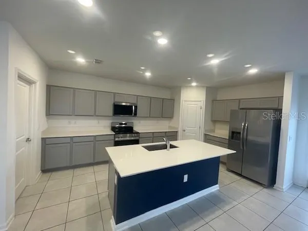a kitchen with a sink appliances and cabinets