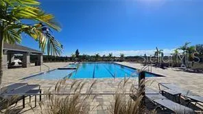 a view of a house with swimming pool and sitting area