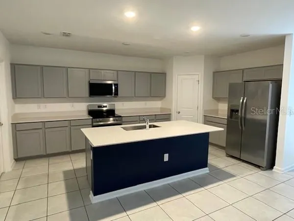 a kitchen with stainless steel appliances granite countertop a sink counter space and cabinets