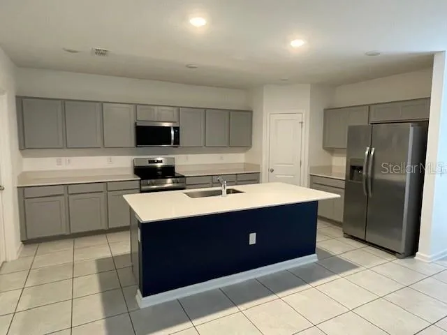 a kitchen with stainless steel appliances granite countertop a sink counter space and cabinets