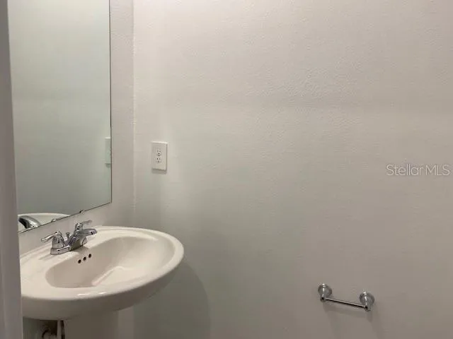 a bathroom with a sink and mirror