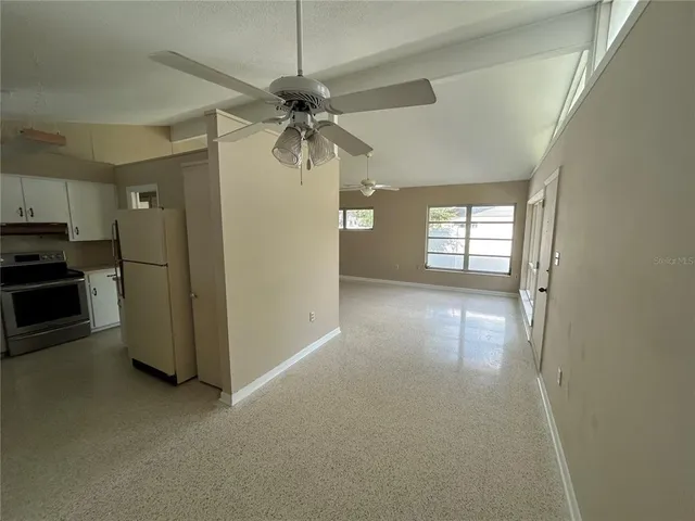 a view of a kitchen with a sink and a ceiling fan