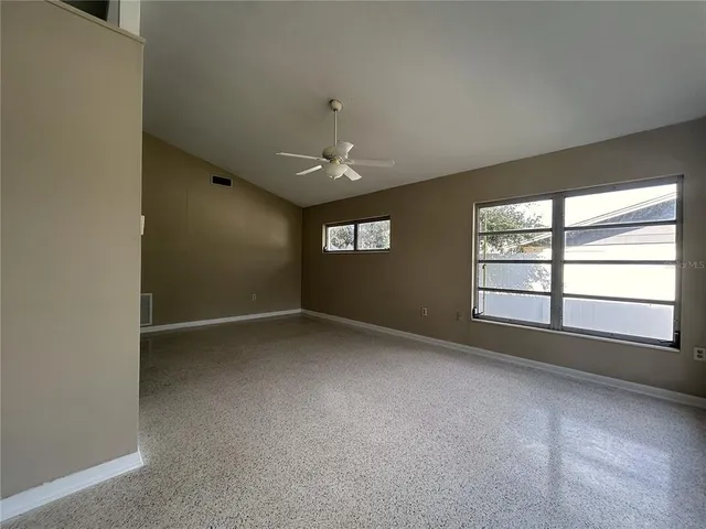 an empty room with a empty space and windows