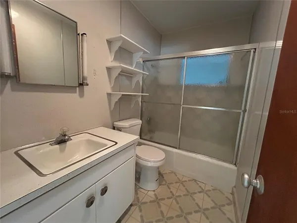 a bathroom with a toilet sink and shower