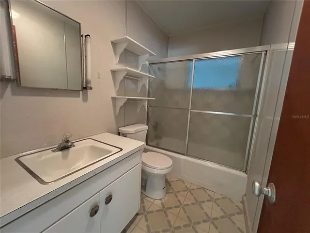 a bathroom with a toilet sink and shower