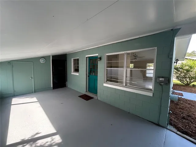 a view of an empty room with large windows