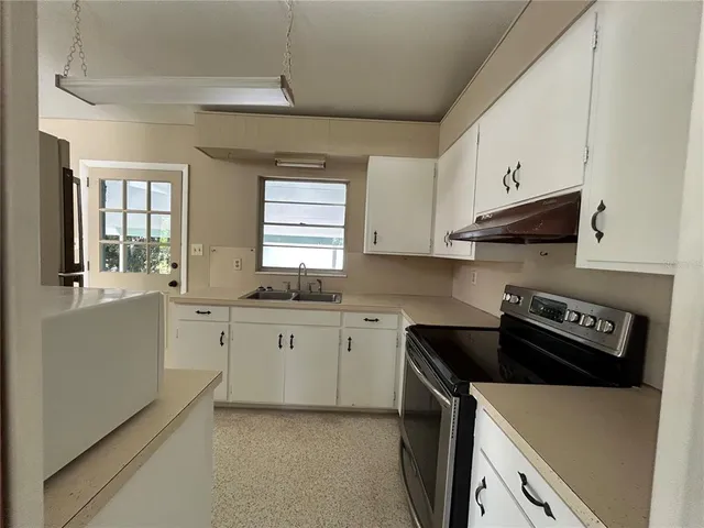 a kitchen that has a sink and a stove