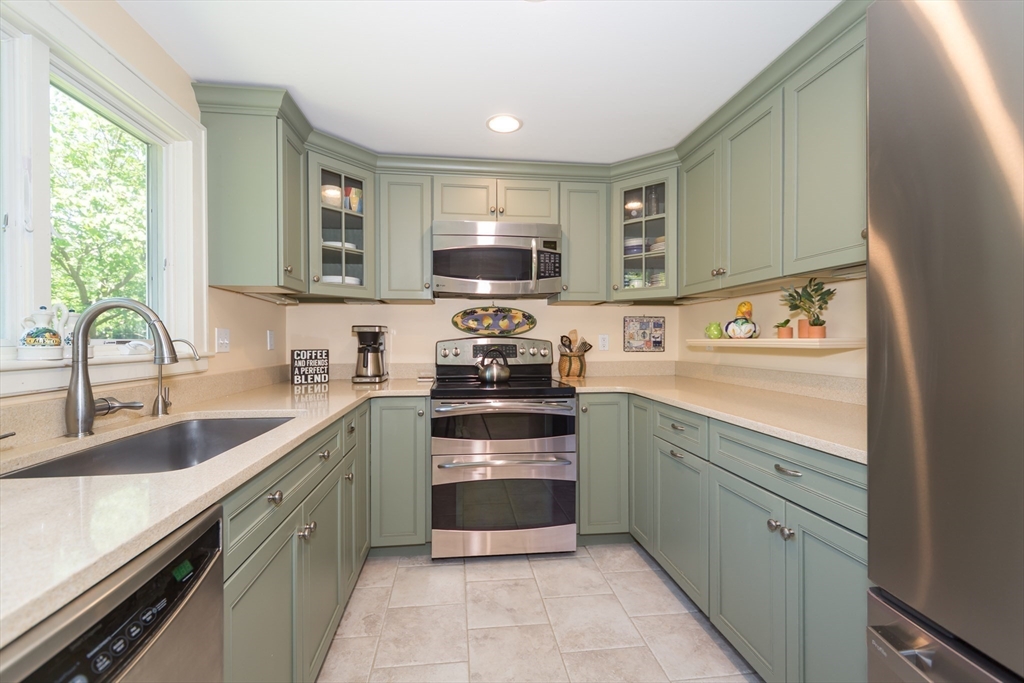 16 Beverly Road Natick, MA 01760 - Photo 20 of 37 a kitchen with a sink stove top oven and cabinets