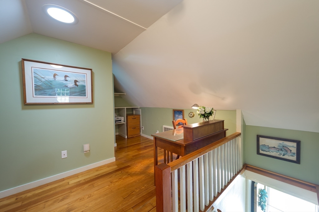 16 Beverly Road Natick, MA 01760 - Photo 26 of 37 a view of a hallway with wooden floor and stairs
