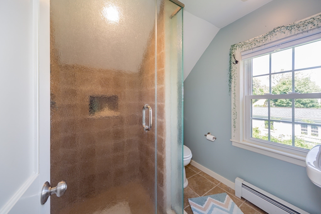 16 Beverly Road Natick, MA 01760 - Photo 29 of 37 a bathroom with a window a shower and toilet