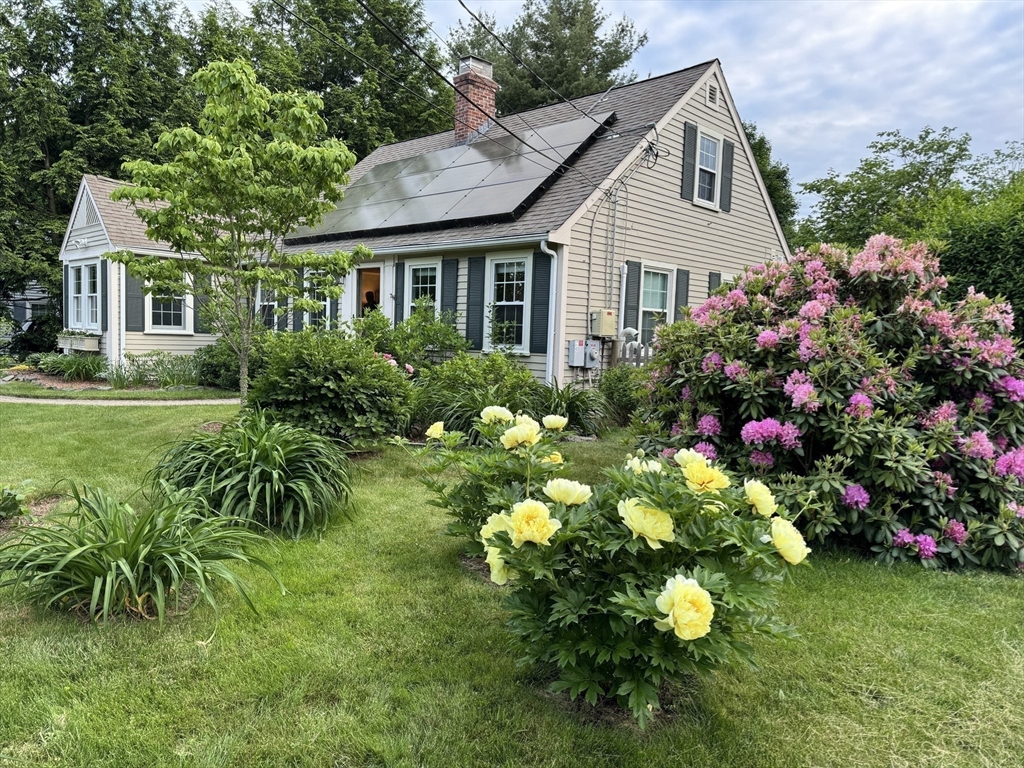 16 Beverly Road Natick, MA 01760 - Photo 4 of 37 a front view of a house with a yard and fountain