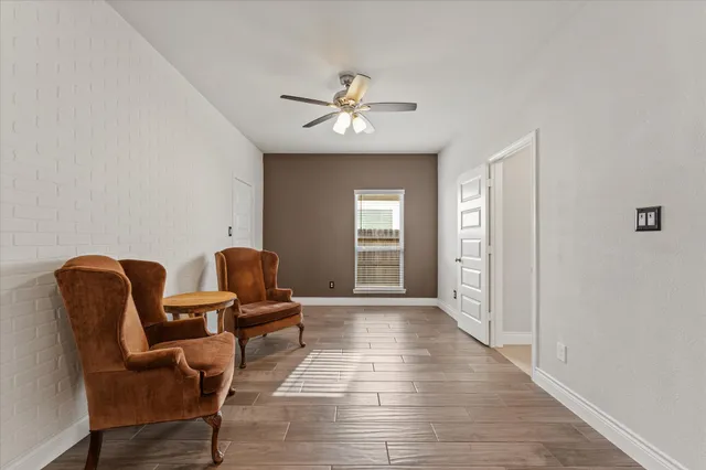 a living room with furniture and a ceiling fan