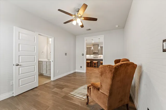 a living room with furniture and a ceiling fan