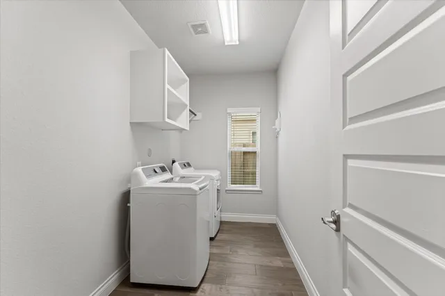 a utility room with a sink a washer and dryer