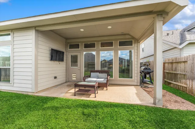 a house view with a sitting space and garden