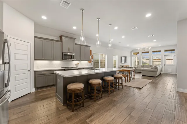 a kitchen with counter top space a sink appliances and cabinets