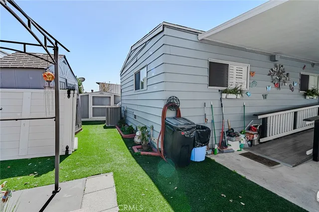 a view of a house with backyard and sitting area