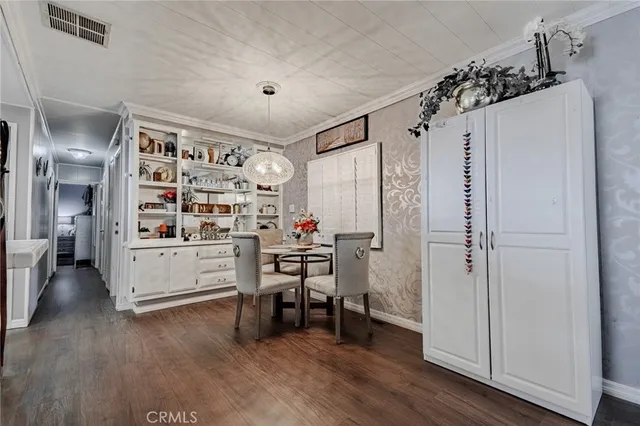 a view of a bedroom with workspace and wooden floor