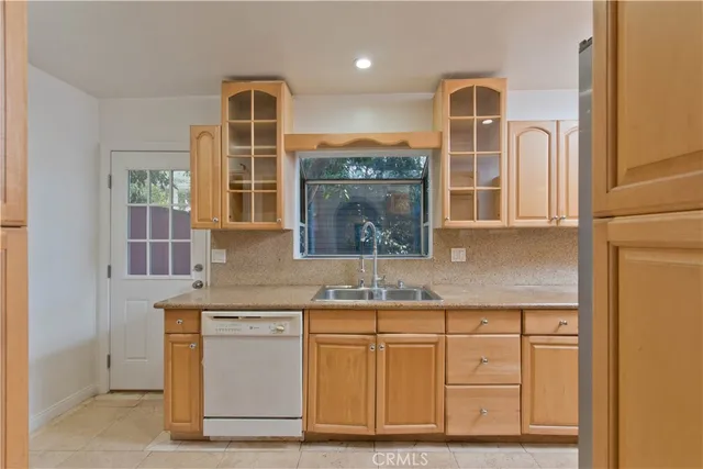 a kitchen with cabinets and window