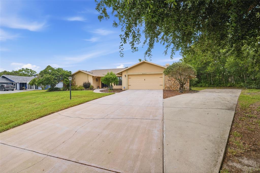5227 Suwannee Road Weeki Wachee, FL 34607 - Photo 3 of 62 a view of a yard with potted plants