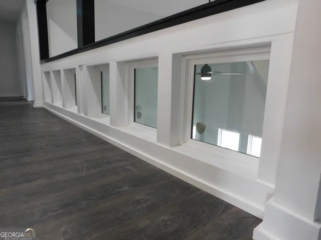 an empty room with wooden floor and closet