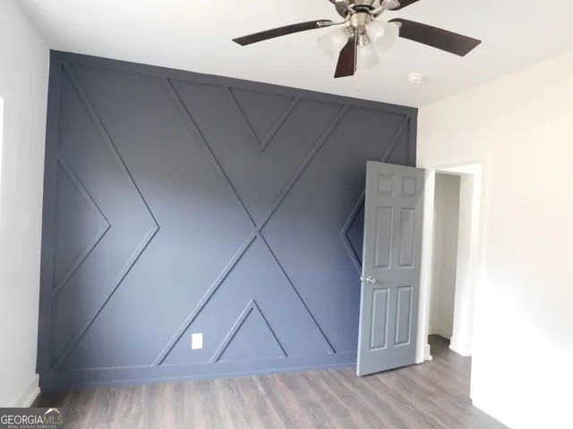 a view of a kitchen with a sink and wooden floor