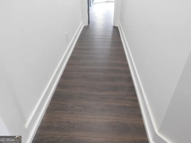 a kitchen with a refrigerator and a stove top oven