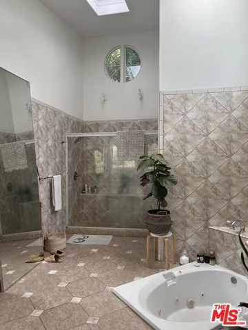 a bedroom with furniture and a large window