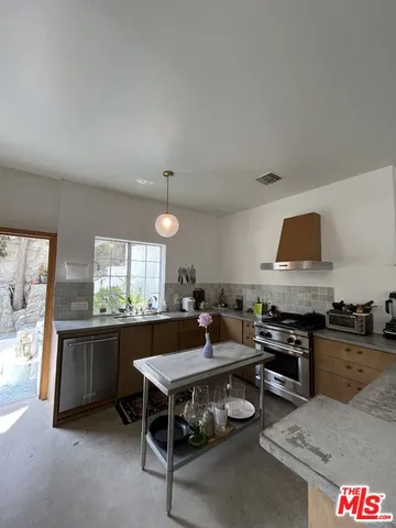 a kitchen with a stove and a refrigerator