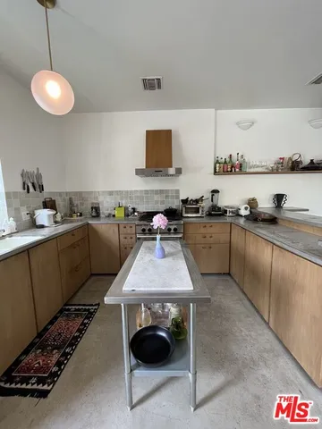 a kitchen with a sink appliances and cabinets