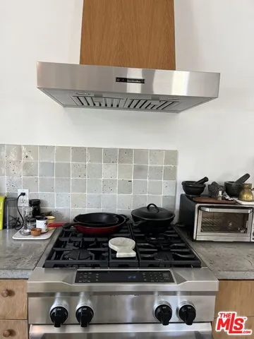 a stove sitting inside of a kitchen with granite countertop