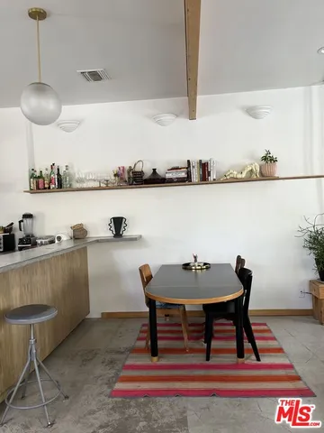 a dining room with furniture and a floor to ceiling window