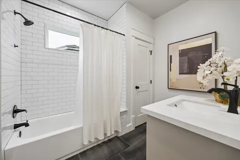 a bathroom with a double vanity sink and mirror